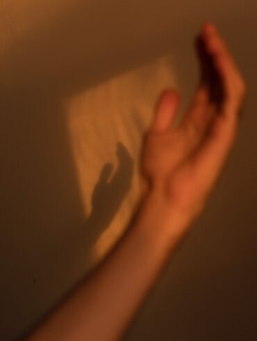 person holding brown and white textile