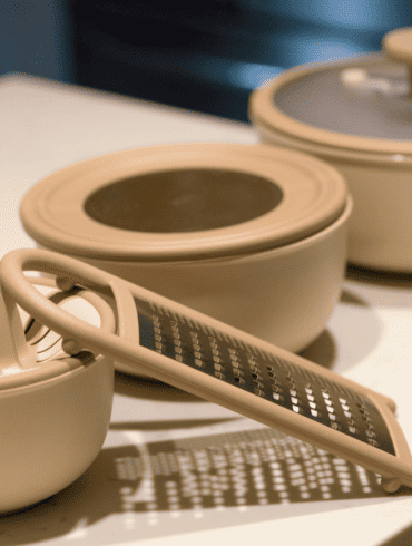 OurPlace's 9-Piece Better Bowl Set in neutral tones, featuring a citrus juicer and grater, for a modern kitchen.