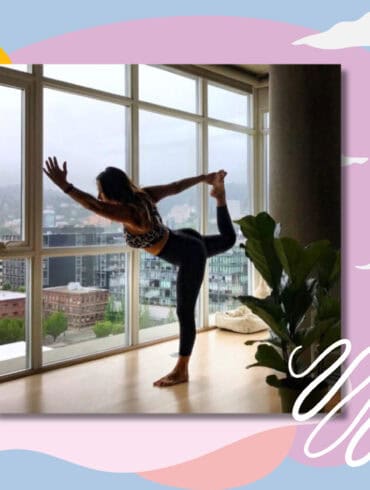 A person practicing yoga in a bright, modern apartment with large windows overlooking a cityscape. The individual is in a balancing pose, standing on one leg while holding the other leg behind them. The background features abstract pastel shapes and lines, with a plant visible to the side, adding a touch of greenery to the serene indoor setting.